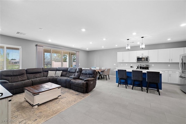 5455 Eleganza Ave, Pahrump, NV 89061 - living room with baseboards, visible vents, and recessed lighting