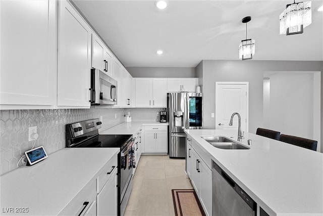 5455 Eleganza Ave, Pahrump, NV 89061 - kitchen featuring white cabinets, appliances with stainless steel finishes, light countertops, a sink, and decorative backsplash