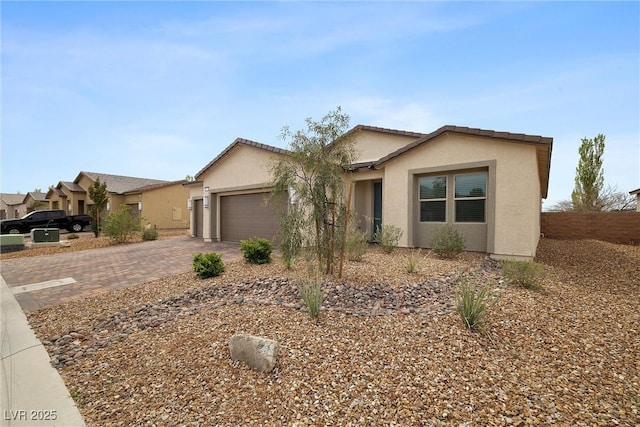5455 Eleganza Ave, Pahrump, NV 89061 - ranch-style home featuring a garage, stucco siding, and driveway