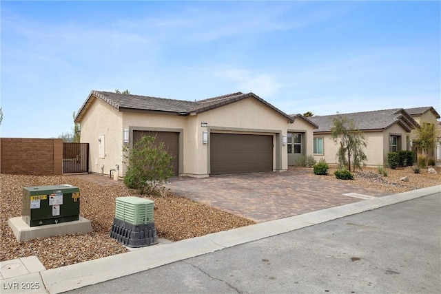 5455 Eleganza Ave, Pahrump, NV 89061 - single story home featuring an attached garage, a tile roof, stucco siding, a gate, and driveway