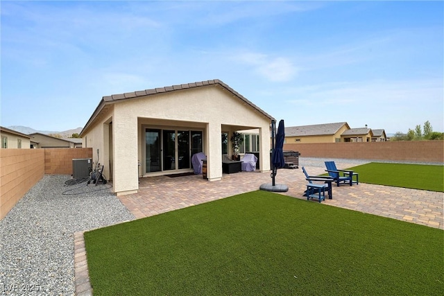 5455 Eleganza Ave, Pahrump, NV 89061 - rear view of property with stucco siding, a patio area, a fenced backyard, central AC, and a yard