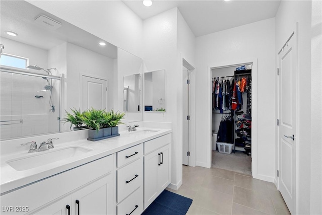 5455 Eleganza Ave, Pahrump, NV 89061 - full bath featuring a sink, a spacious closet, double vanity, and a stall shower