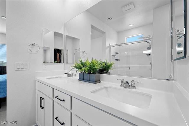 5455 Eleganza Ave, Pahrump, NV 89061 - ensuite bathroom featuring a shower stall, double vanity, visible vents, and a sink