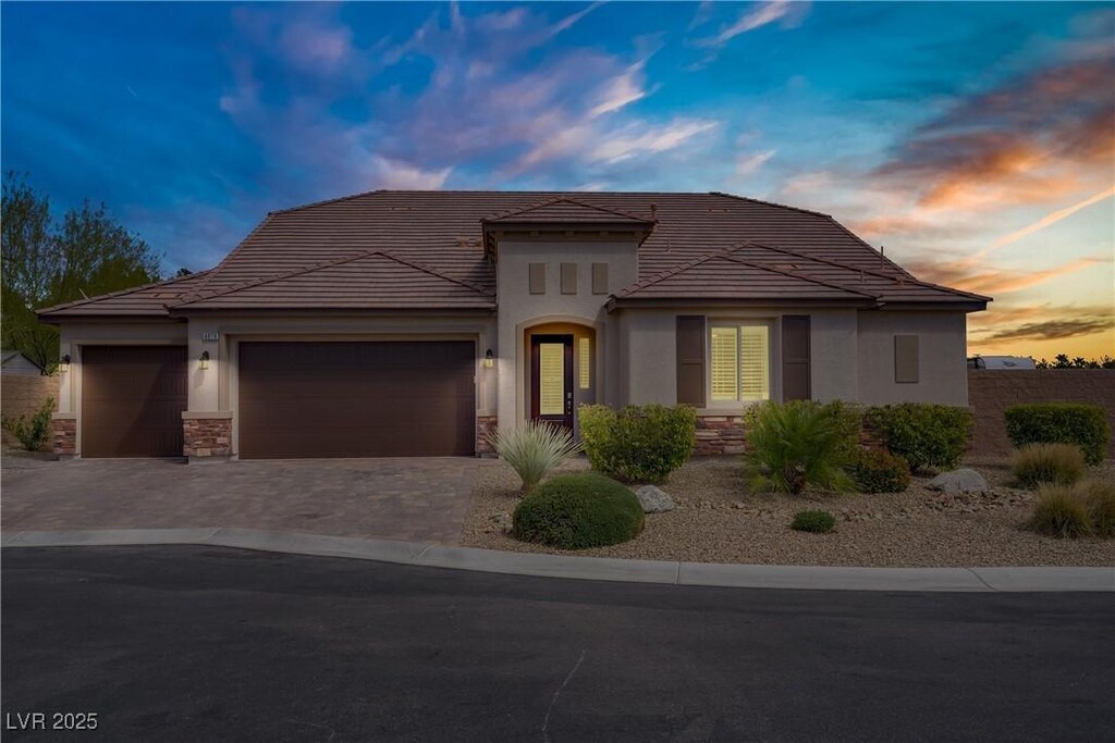 4878 Al Carrison St, Las Vegas, NV 89149 - view of front facade with stucco siding, stone siding, and a tile roof