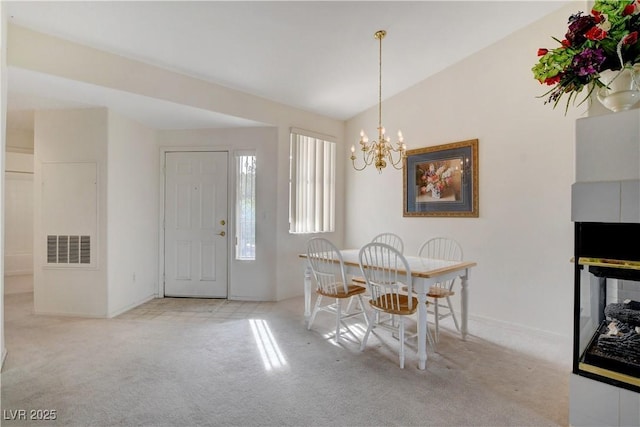 dining room with visible vents, vaulted ceiling, a chandelier, carpet floors, and baseboards