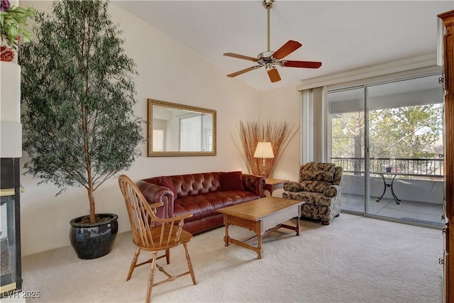 living area with vaulted ceiling, a ceiling fan, and carpet