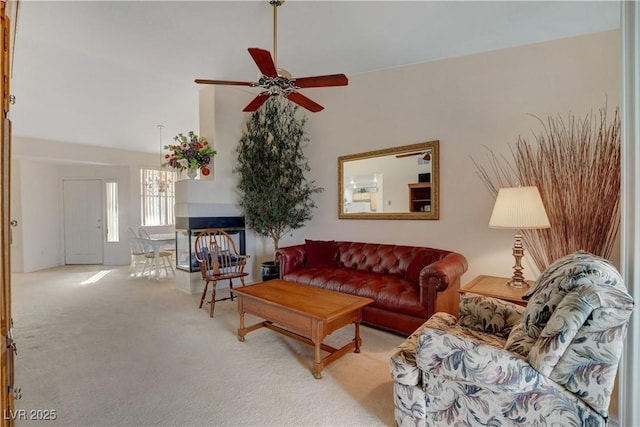 living room with a ceiling fan and carpet flooring