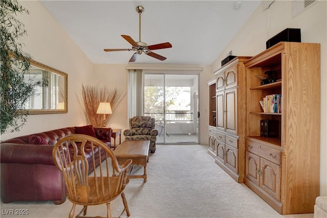 living room with a ceiling fan, light carpet, and lofted ceiling