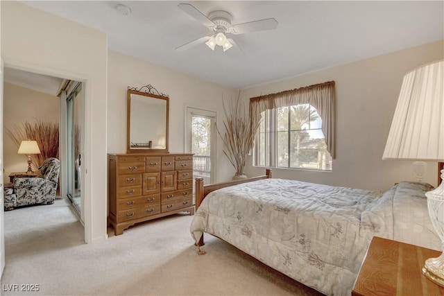 bedroom with a ceiling fan and light carpet