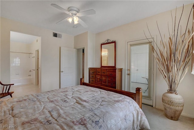 bedroom with carpet, ensuite bath, a ceiling fan, and visible vents