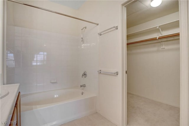 full bathroom featuring a spacious closet, vanity, and shower / washtub combination