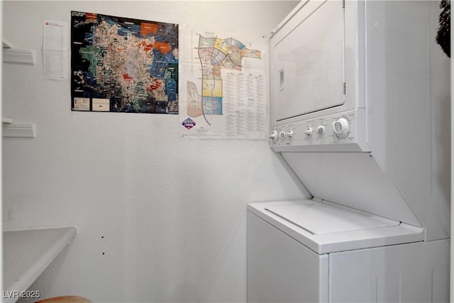 laundry area with stacked washer and dryer and laundry area
