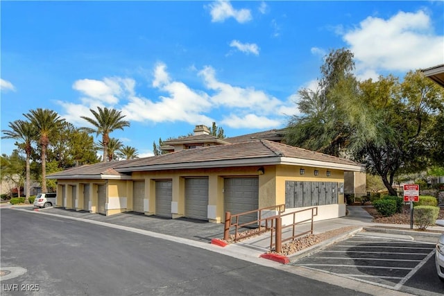 exterior space featuring community garages and stucco siding