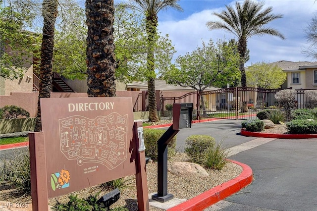 community / neighborhood sign with fence