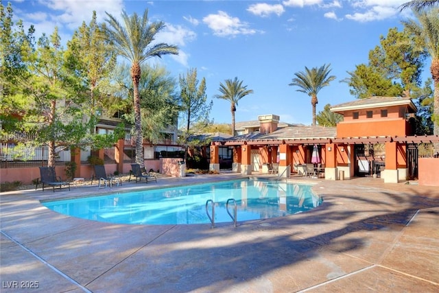 pool featuring a patio area and fence