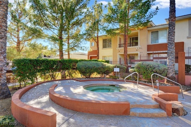 surrounding community featuring a jacuzzi and fence