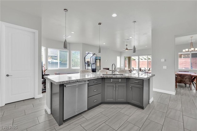 kitchen with gray cabinets, a healthy amount of sunlight, stainless steel dishwasher, and a sink