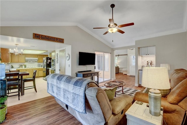 living room featuring light wood finished floors, ceiling fan with notable chandelier, crown molding, and lofted ceiling