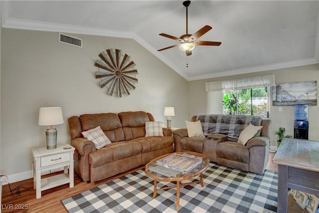 living area with crown molding, visible vents, a ceiling fan, and wood finished floors