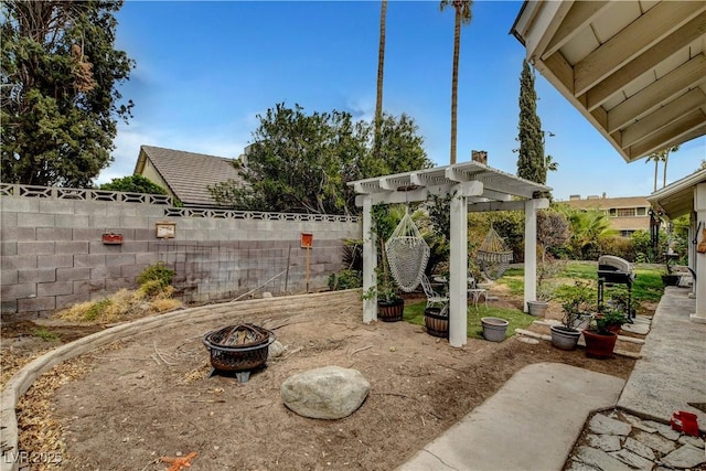 view of yard with a pergola, a fire pit, and a fenced backyard