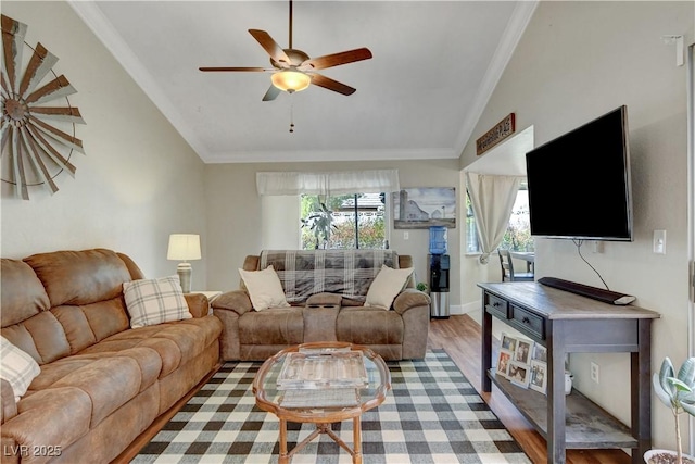 living room with lofted ceiling, crown molding, and a healthy amount of sunlight