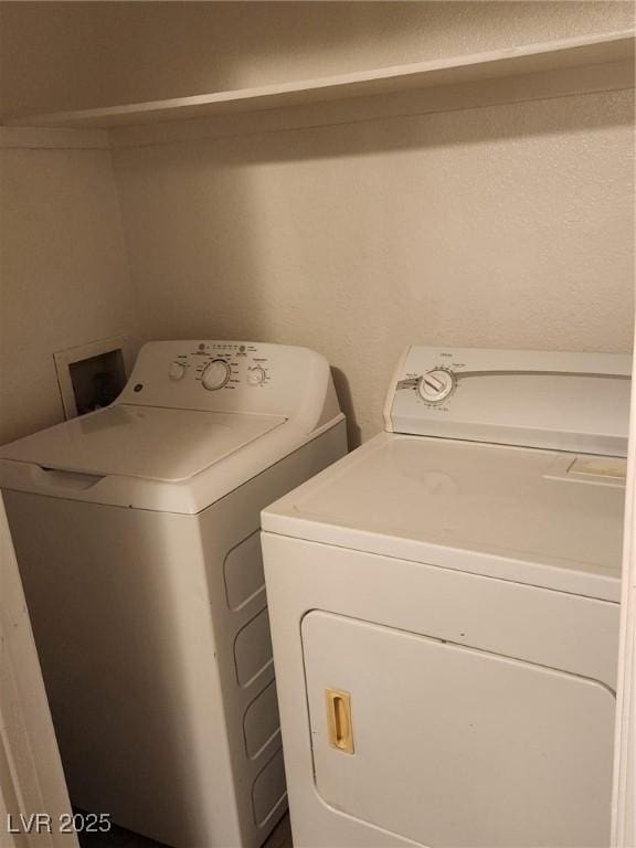 laundry room with washing machine and clothes dryer and laundry area