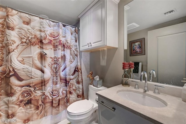 bathroom featuring toilet, visible vents, vanity, and a shower with shower curtain