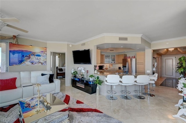 living area featuring ornamental molding, a ceiling fan, and visible vents