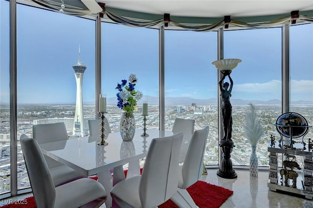 dining room featuring a mountain view and floor to ceiling windows