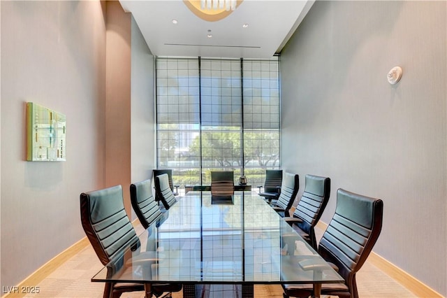 dining space with baseboards and floor to ceiling windows