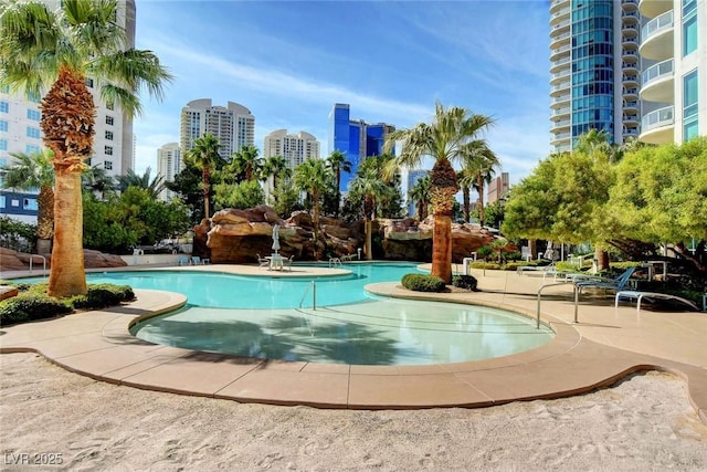 community pool featuring a view of city and a patio