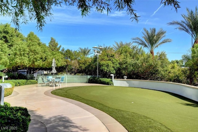view of community with a patio and fence