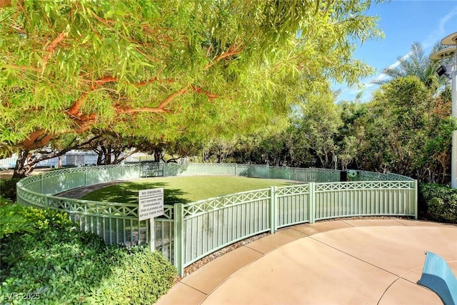 view of property's community featuring a yard and fence