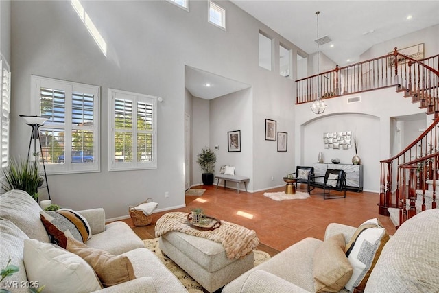 9413 Artesian Oak Ct, Las Vegas, NV 89149 - living room featuring plenty of natural light, wood finished floors, a towering ceiling, and stairs