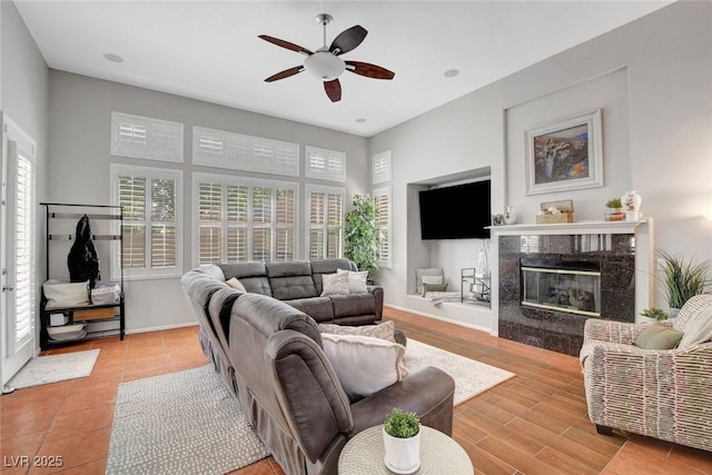 9413 Artesian Oak Ct, Las Vegas, NV 89149 - living area with a fireplace, baseboards, and ceiling fan