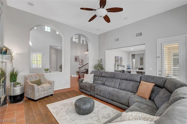 9413 Artesian Oak Ct, Las Vegas, NV 89149 - living room with ceiling fan, arched walkways, stairs, and visible vents