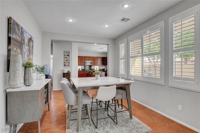9413 Artesian Oak Ct, Las Vegas, NV 89149 - dining area with recessed lighting, plenty of natural light, visible vents, and light tile patterned floors