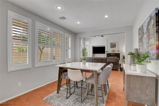 9413 Artesian Oak Ct, Las Vegas, NV 89149 - dining room featuring recessed lighting, a tile fireplace, visible vents, light tile patterned flooring, and baseboards