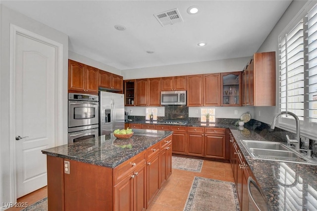 9413 Artesian Oak Ct, Las Vegas, NV 89149 - kitchen featuring brown cabinets, visible vents, appliances with stainless steel finishes, and a sink