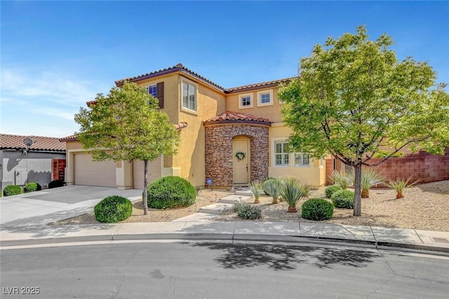 9413 Artesian Oak Ct, Las Vegas, NV 89149 - mediterranean / spanish home with a tiled roof, concrete driveway, an attached garage, stucco siding, and stone siding