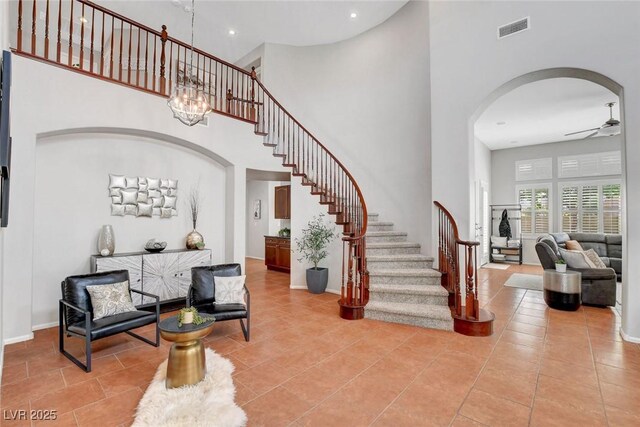 9413 Artesian Oak Ct, Las Vegas, NV 89149 - foyer with arched walkways, visible vents, a towering ceiling, and stairs