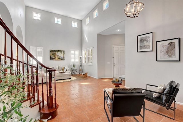 9413 Artesian Oak Ct, Las Vegas, NV 89149 - foyer featuring light tile patterned flooring, baseboards, a towering ceiling, a chandelier, and stairway