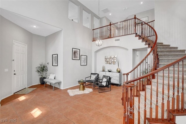 9413 Artesian Oak Ct, Las Vegas, NV 89149 - foyer entrance with tile patterned floors, visible vents, recessed lighting, a high ceiling, and stairs