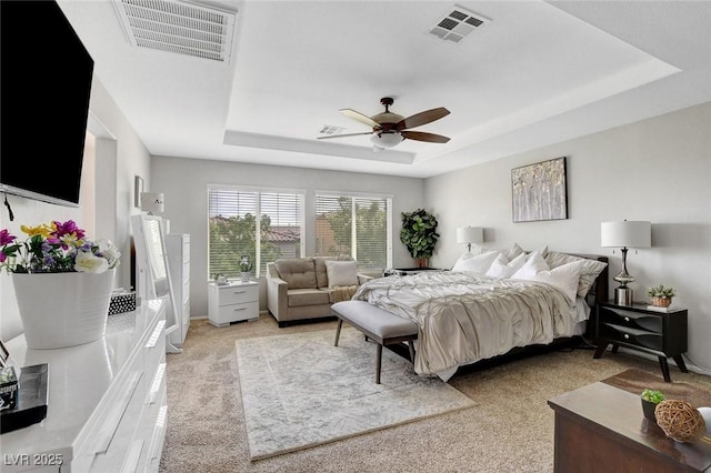 9413 Artesian Oak Ct, Las Vegas, NV 89149 - bedroom featuring light carpet, a ceiling fan, a tray ceiling, and visible vents