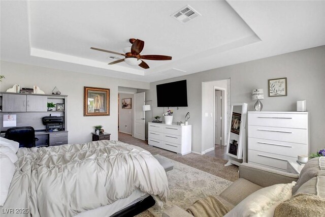 9413 Artesian Oak Ct, Las Vegas, NV 89149 - bedroom featuring ceiling fan, carpet floors, a tray ceiling, baseboards, and visible vents