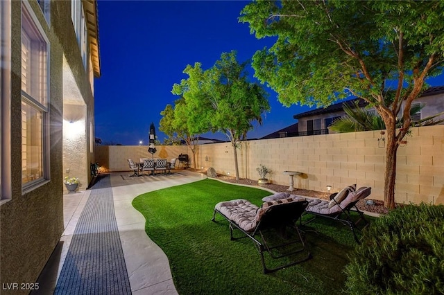 9413 Artesian Oak Ct, Las Vegas, NV 89149 - yard at twilight featuring a fenced backyard and a patio
