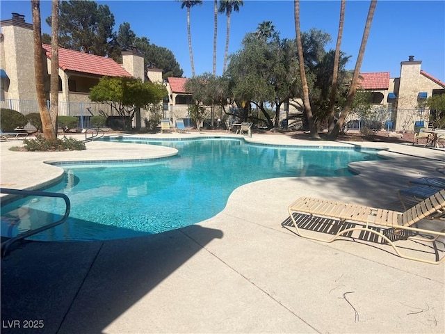 pool featuring a patio and fence