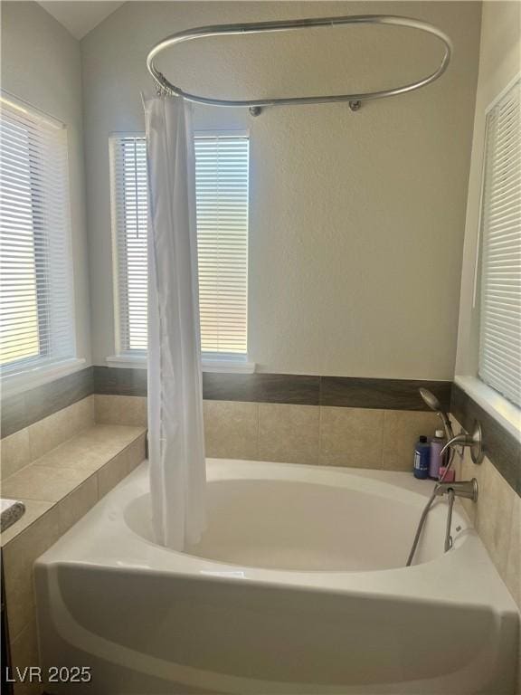 full bathroom with a tub to relax in