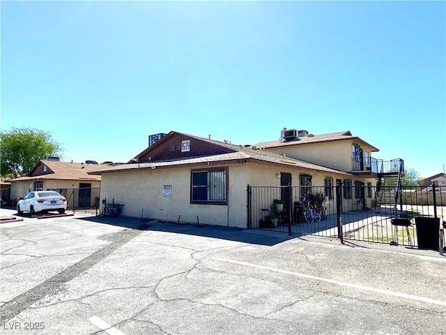 view of front of property featuring stucco siding and fence