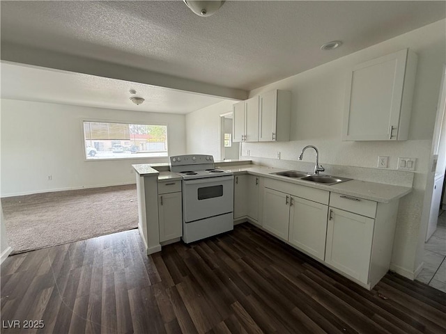 kitchen with white cabinetry, light countertops, a textured ceiling, white electric range oven, and a sink